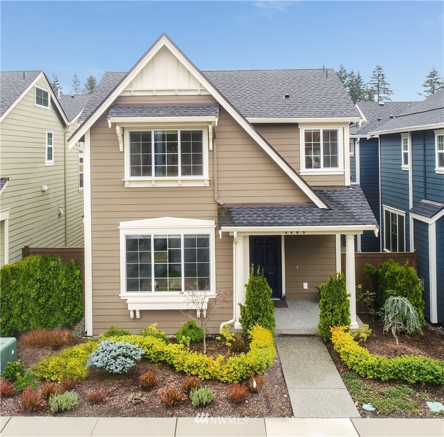 a front view of a house with a yard and outdoor seating