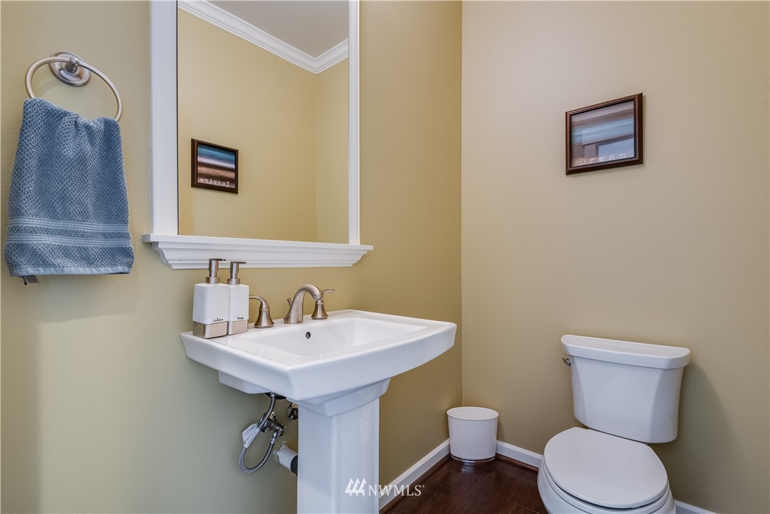 4408 186th Street Southeast Bothell, WA 98012 - Photo 12 of 23 a bathroom with a toilet a sink and mirror