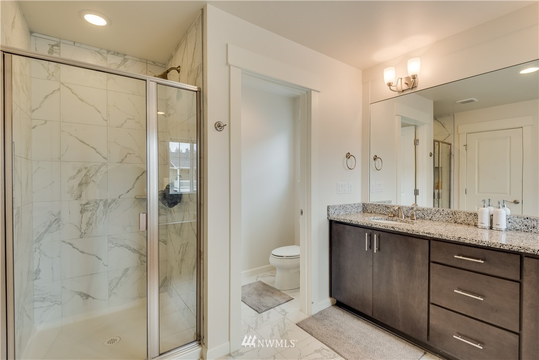 4408 186th Street Southeast Bothell, WA 98012 - Photo 18 of 23 a bathroom with a granite countertop sink toilet and shower