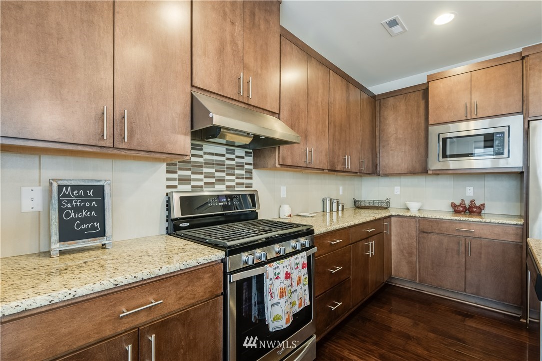 4408 186th Street Southeast Bothell, WA 98012 - Photo 8 of 23 a kitchen with stainless steel appliances granite countertop a stove a sink and a microwave