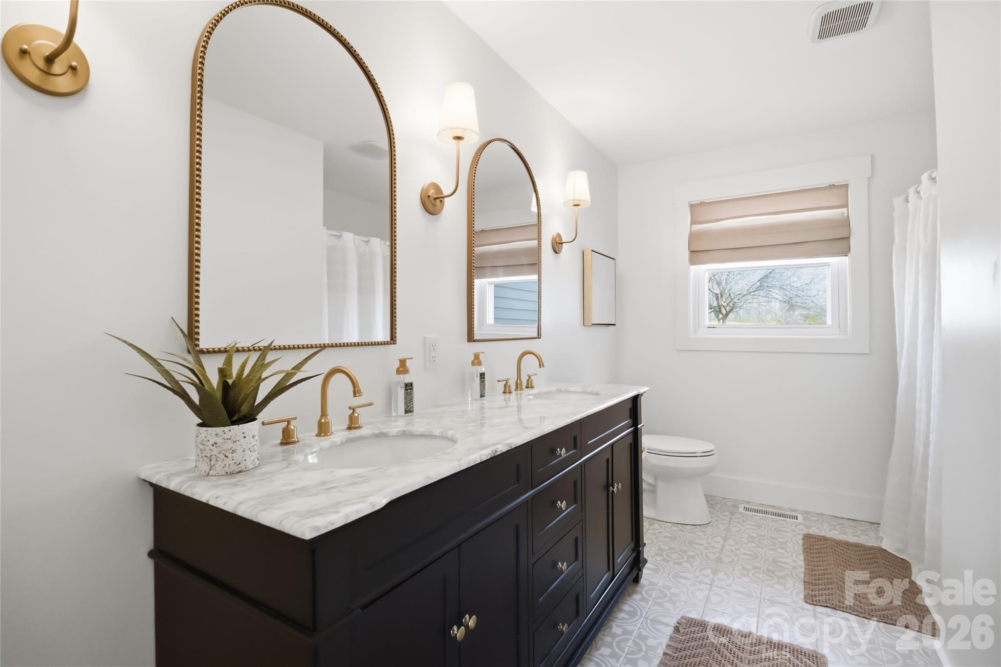 28461 Canton Road Albemarle, NC 28001 - Photo 16 of 30 a bathroom with a toilet sink and mirror