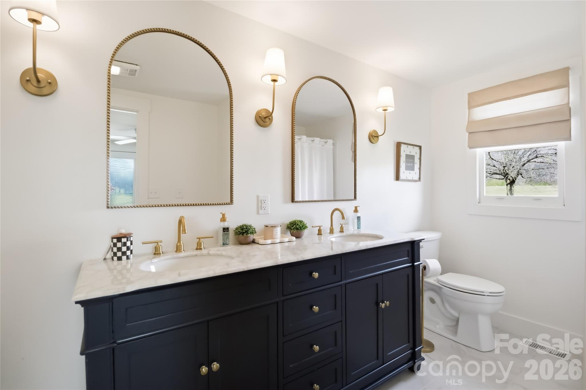 28461 Canton Road Albemarle, NC 28001 - Photo 24 of 30 a bathroom with a double vanity sink a toilet and a mirror