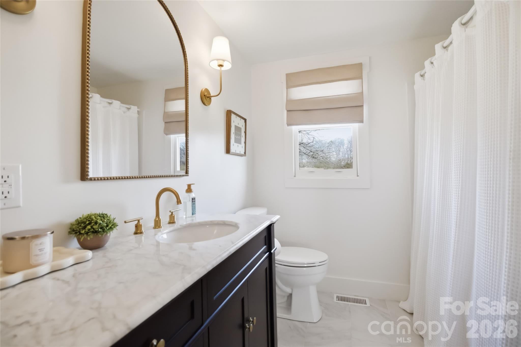 28461 Canton Road Albemarle, NC 28001 - Photo 26 of 30 a bathroom with a granite countertop sink mirror vanity and toilet