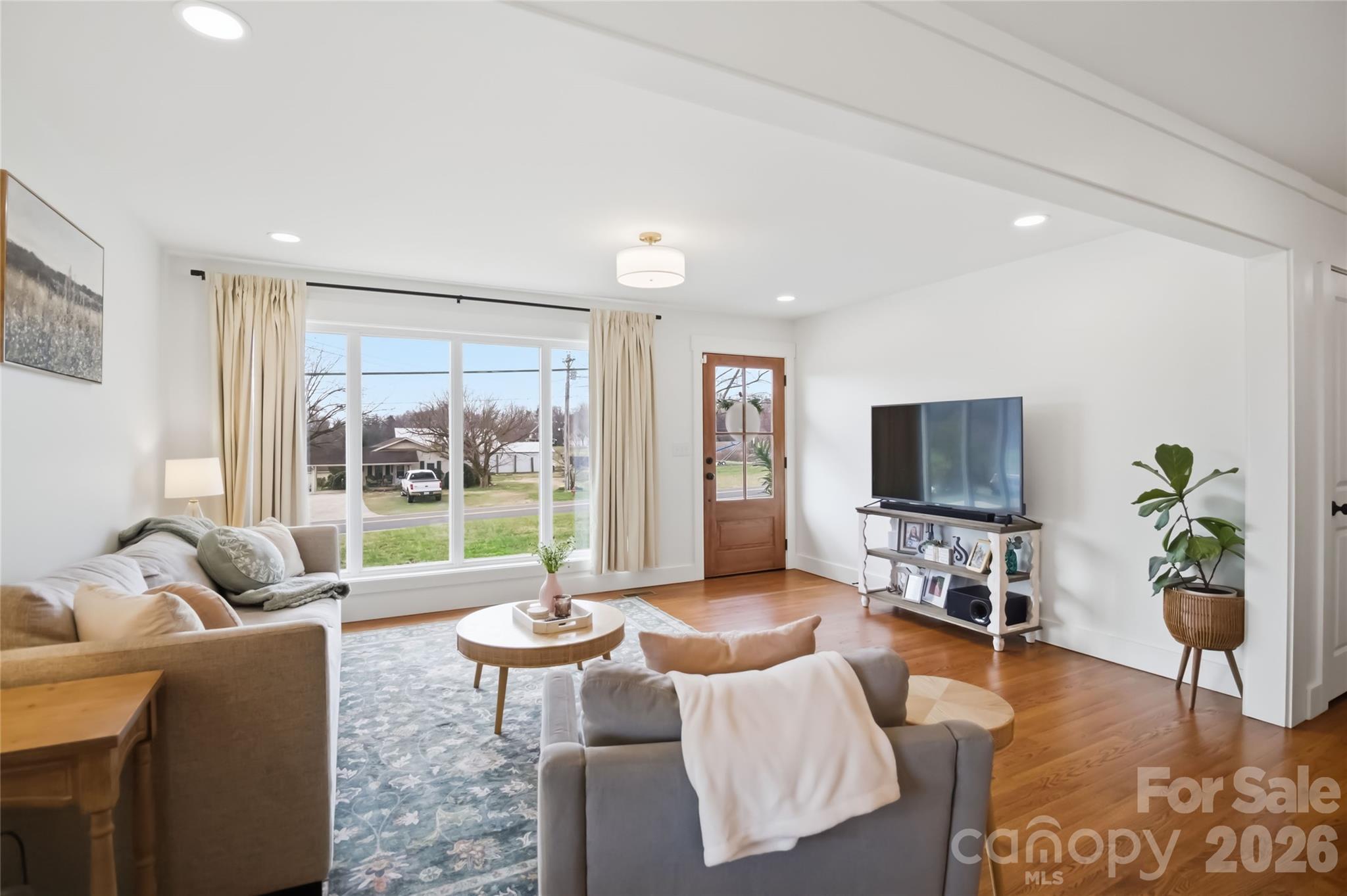 28461 Canton Road Albemarle, NC 28001 - Photo 7 of 30 a living room with furniture a flat screen tv and a large window