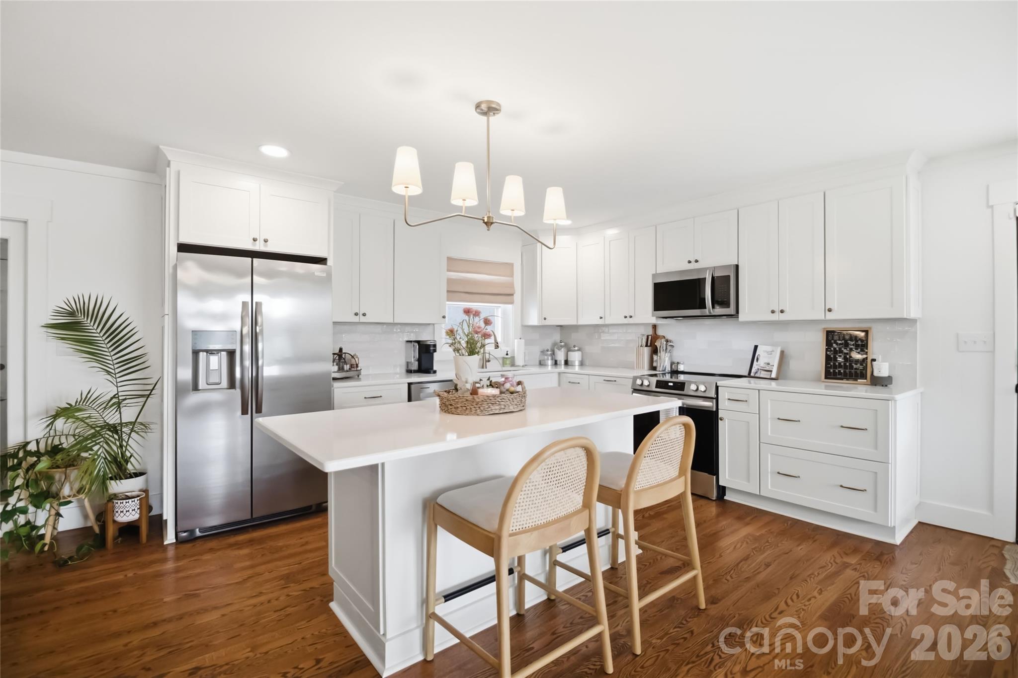 28461 Canton Road Albemarle, NC 28001 - Photo 8 of 30 a kitchen with white cabinets stainless steel appliances and kitchen island