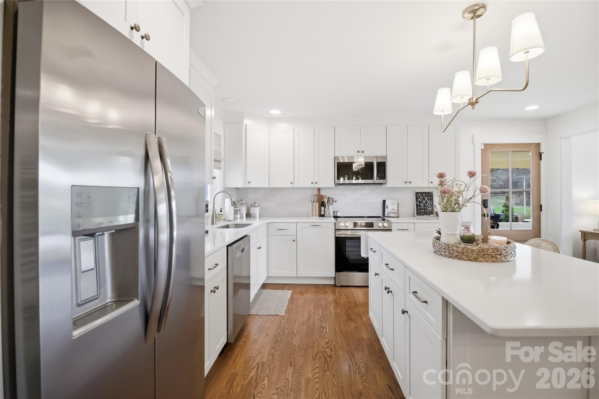 28461 Canton Road Albemarle, NC 28001 - Photo 9 of 30 a kitchen with white cabinets and stainless steel appliances