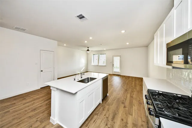 a kitchen with a stove and a sink