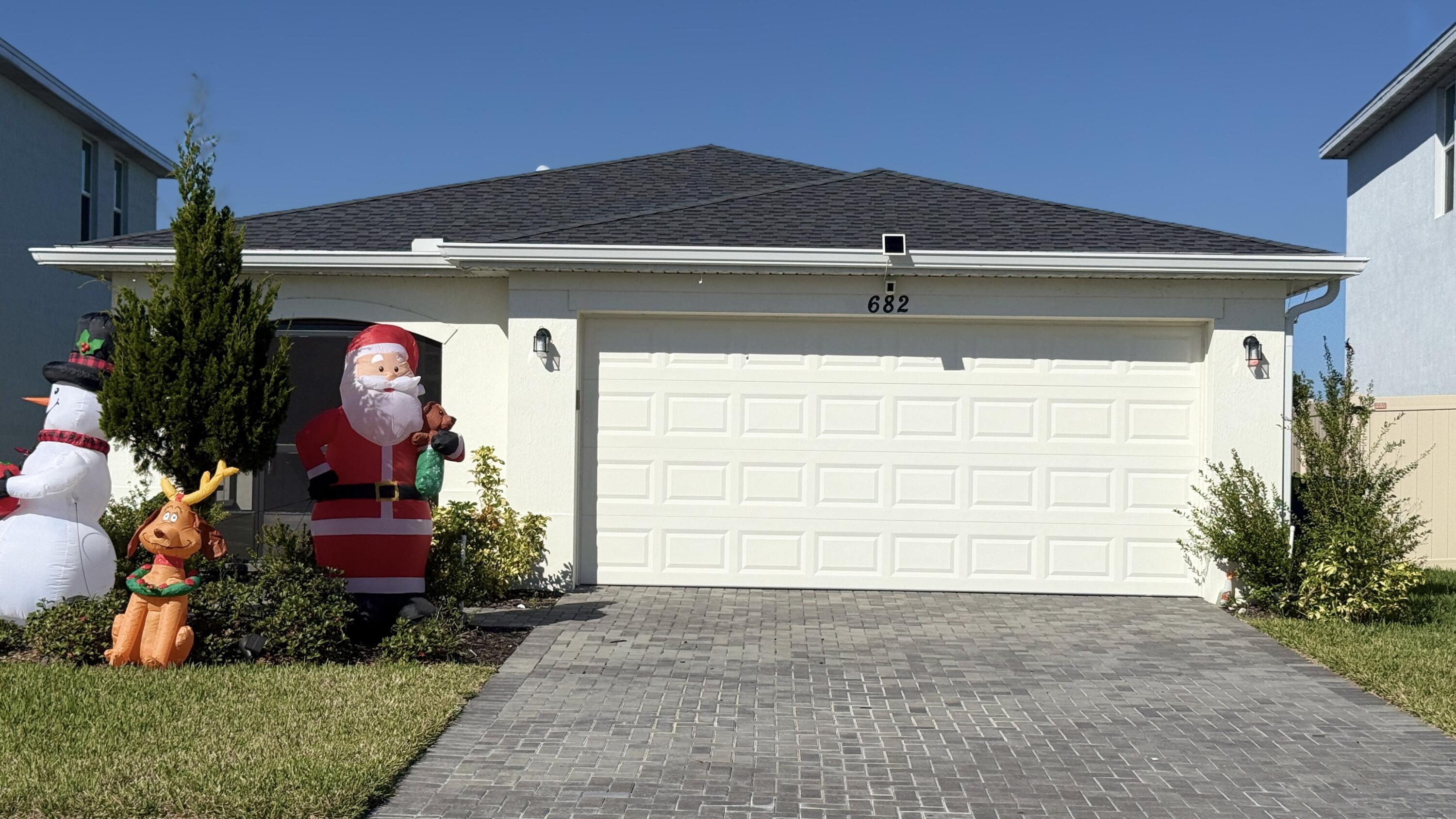 682 Papillon Street Southwest Palm Bay, FL 32908 - Photo 1 of 30 a couple of potted plants in front of door