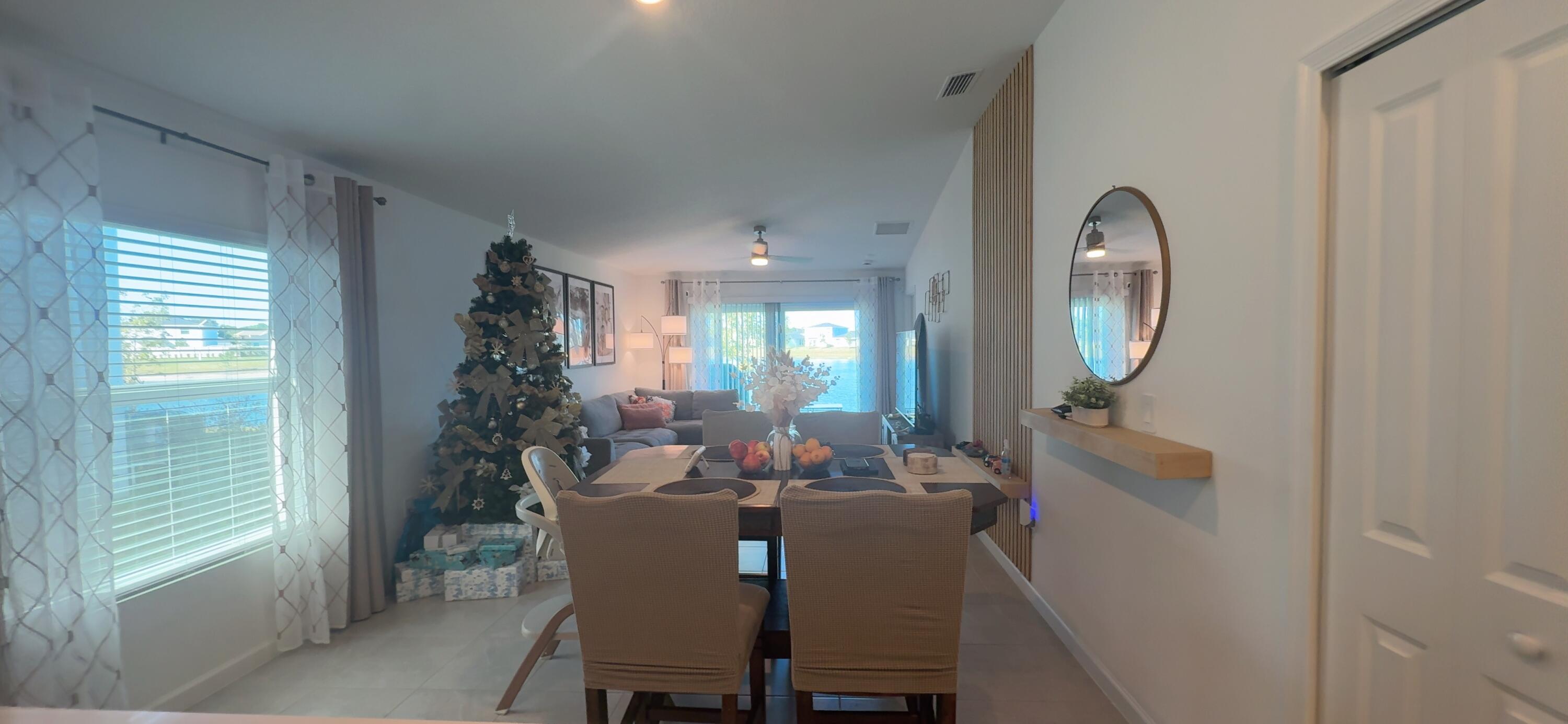 682 Papillon Street Southwest Palm Bay, FL 32908 - Photo 11 of 30 a view of a dining room with furniture and a mirror