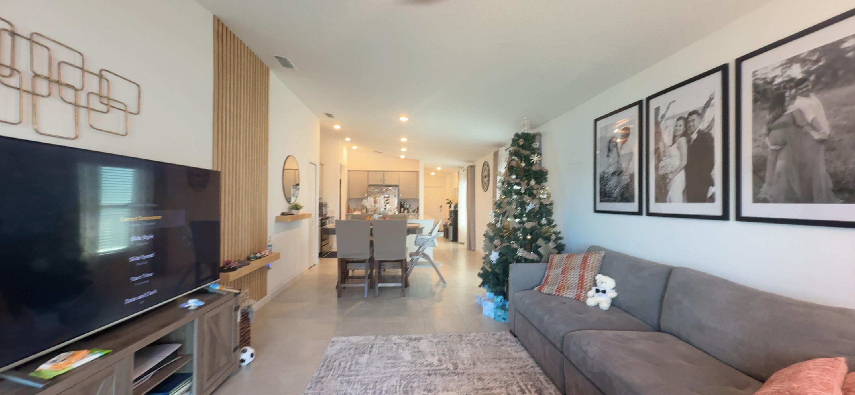 682 Papillon Street Southwest Palm Bay, FL 32908 - Photo 14 of 30 a living room with furniture and a flat screen tv
