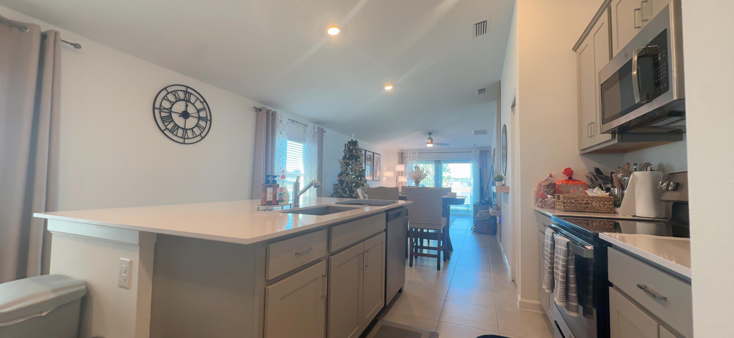 682 Papillon Street Southwest Palm Bay, FL 32908 - Photo 16 of 30 a kitchen with a sink and a stove top oven