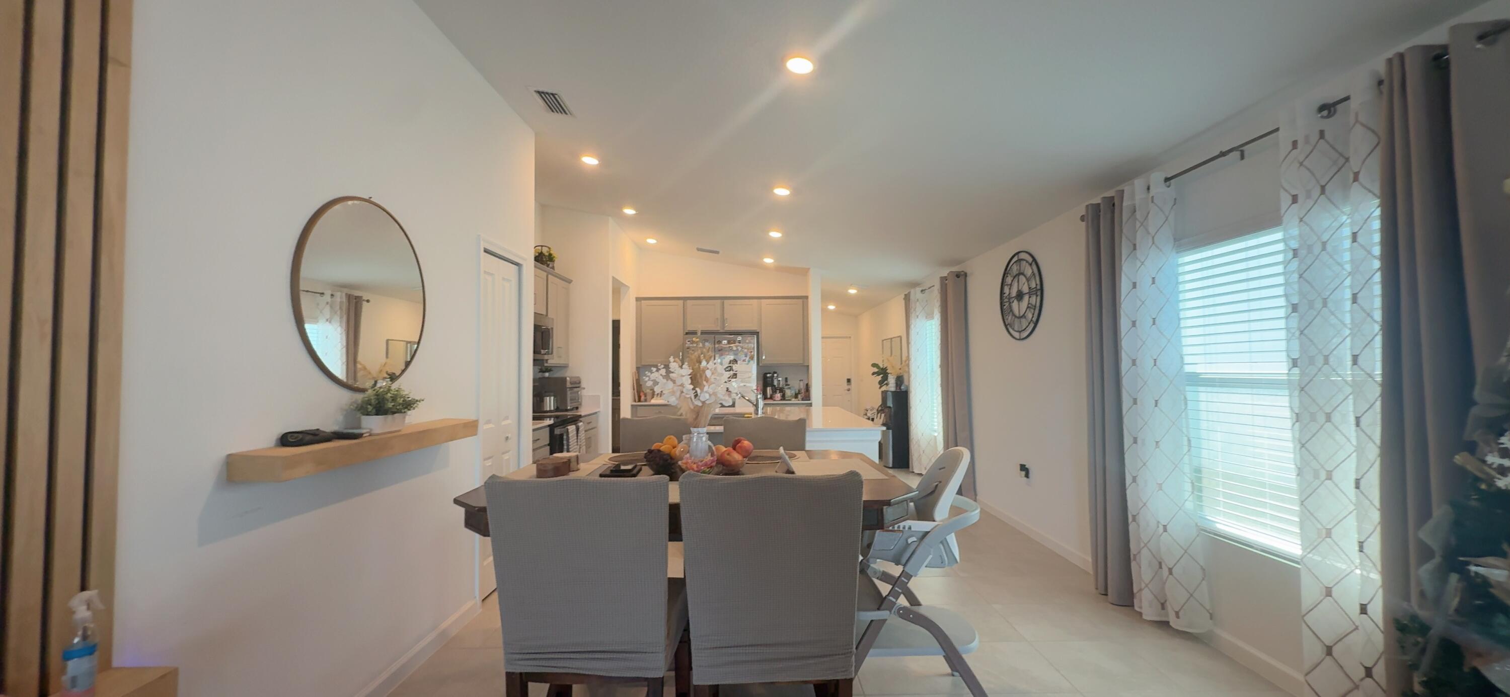 682 Papillon Street Southwest Palm Bay, FL 32908 - Photo 17 of 30 a room with dining table and chairs