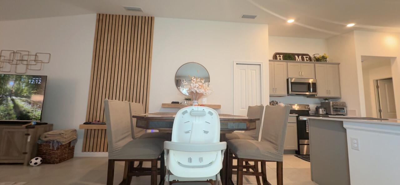 682 Papillon Street Southwest Palm Bay, FL 32908 - Photo 19 of 30 a living room with furniture and a flat screen tv