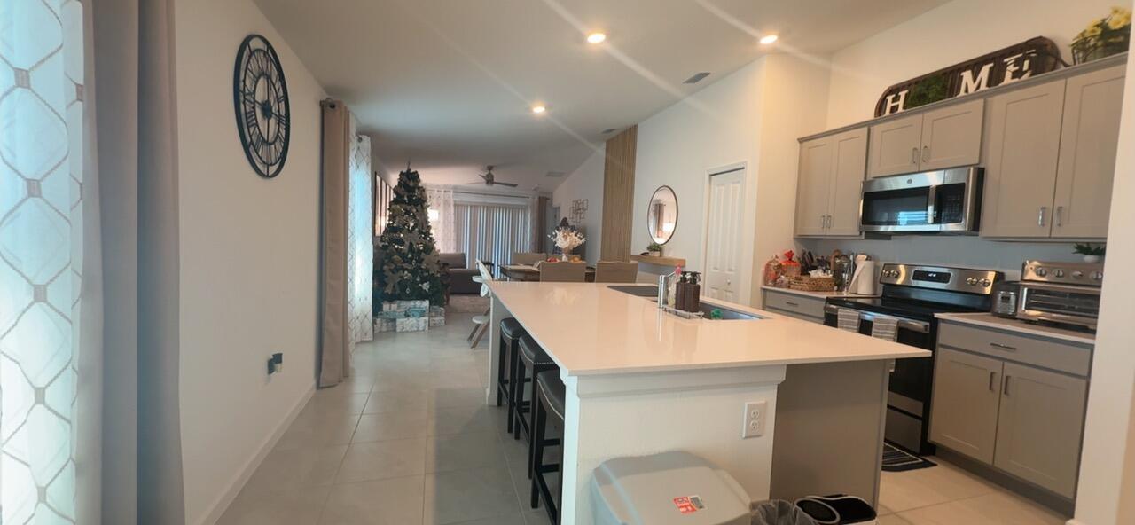 682 Papillon Street Southwest Palm Bay, FL 32908 - Photo 21 of 30 a kitchen with a sink appliances and cabinets