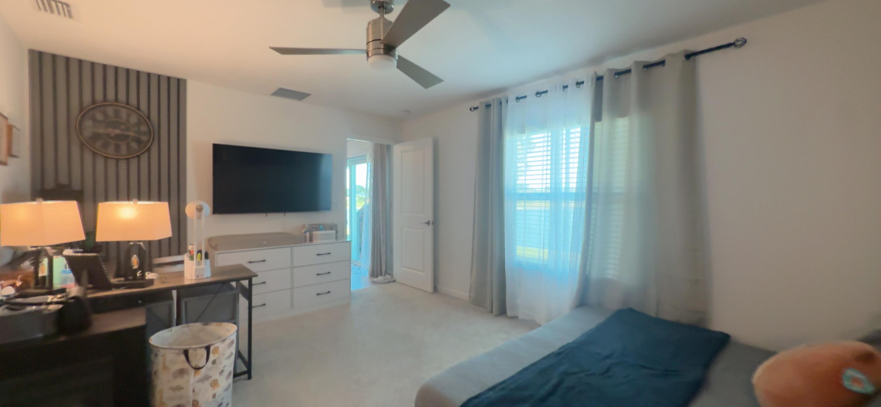 682 Papillon Street Southwest Palm Bay, FL 32908 - Photo 27 of 30 a living room with furniture and a flat screen tv