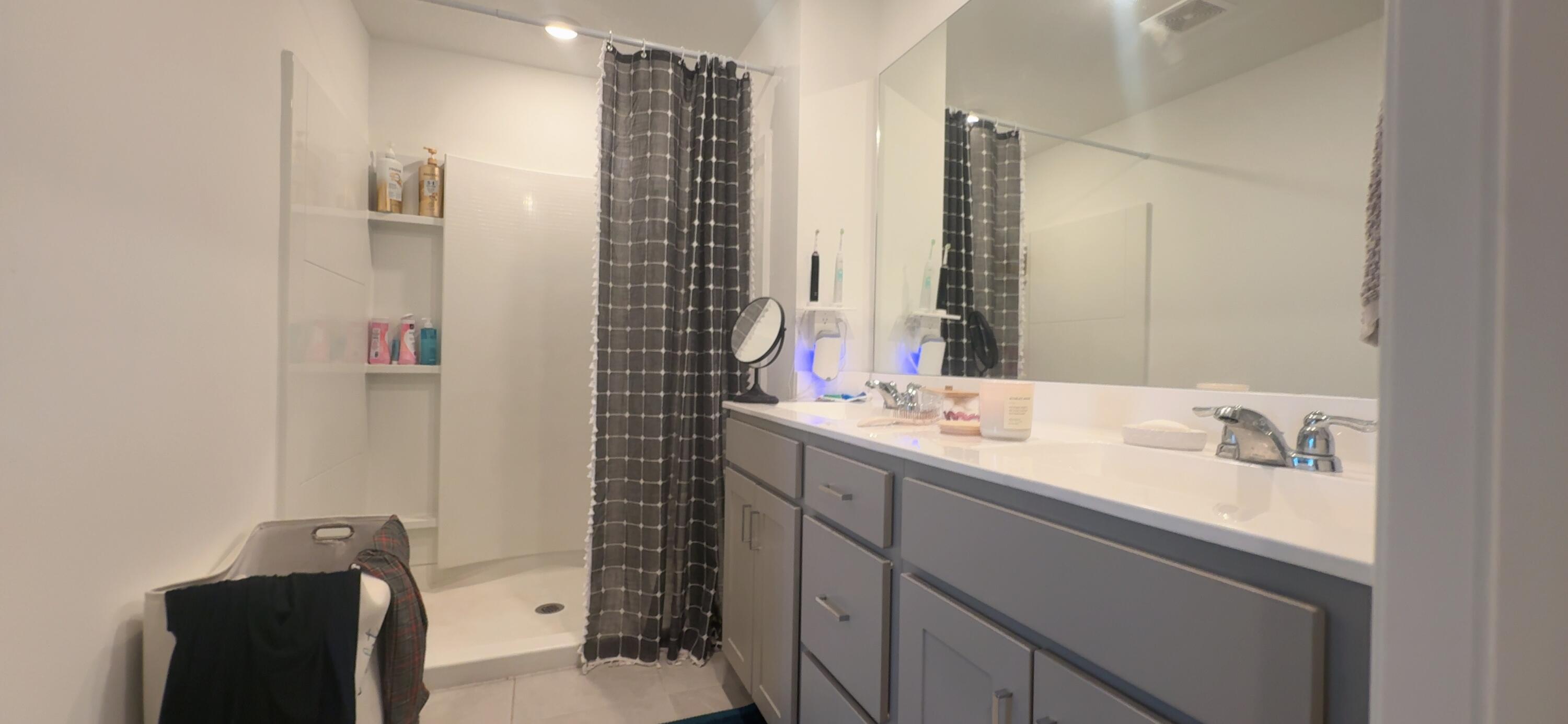 682 Papillon Street Southwest Palm Bay, FL 32908 - Photo 28 of 30 a bathroom with a sink and a mirror