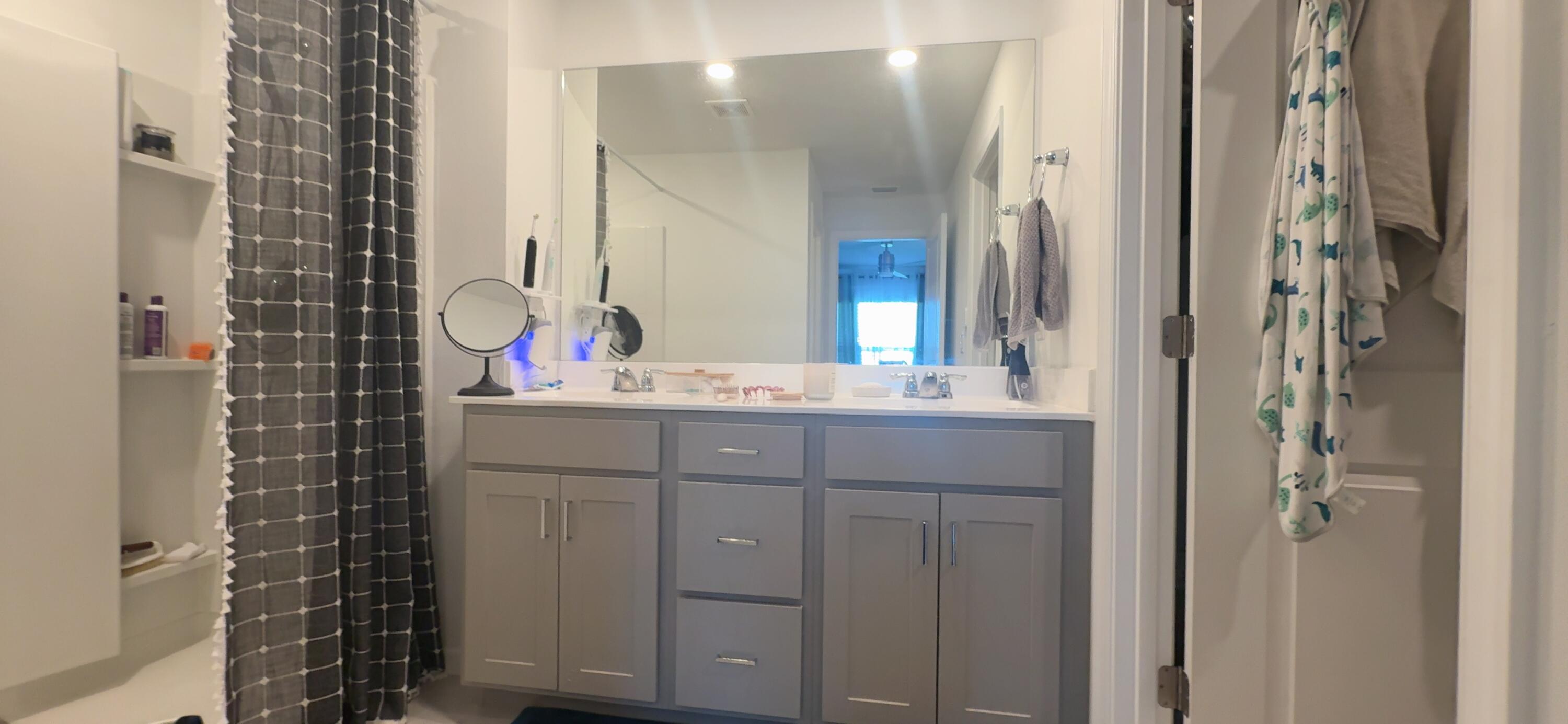 682 Papillon Street Southwest Palm Bay, FL 32908 - Photo 29 of 30 a bathroom with a shower sink and mirror