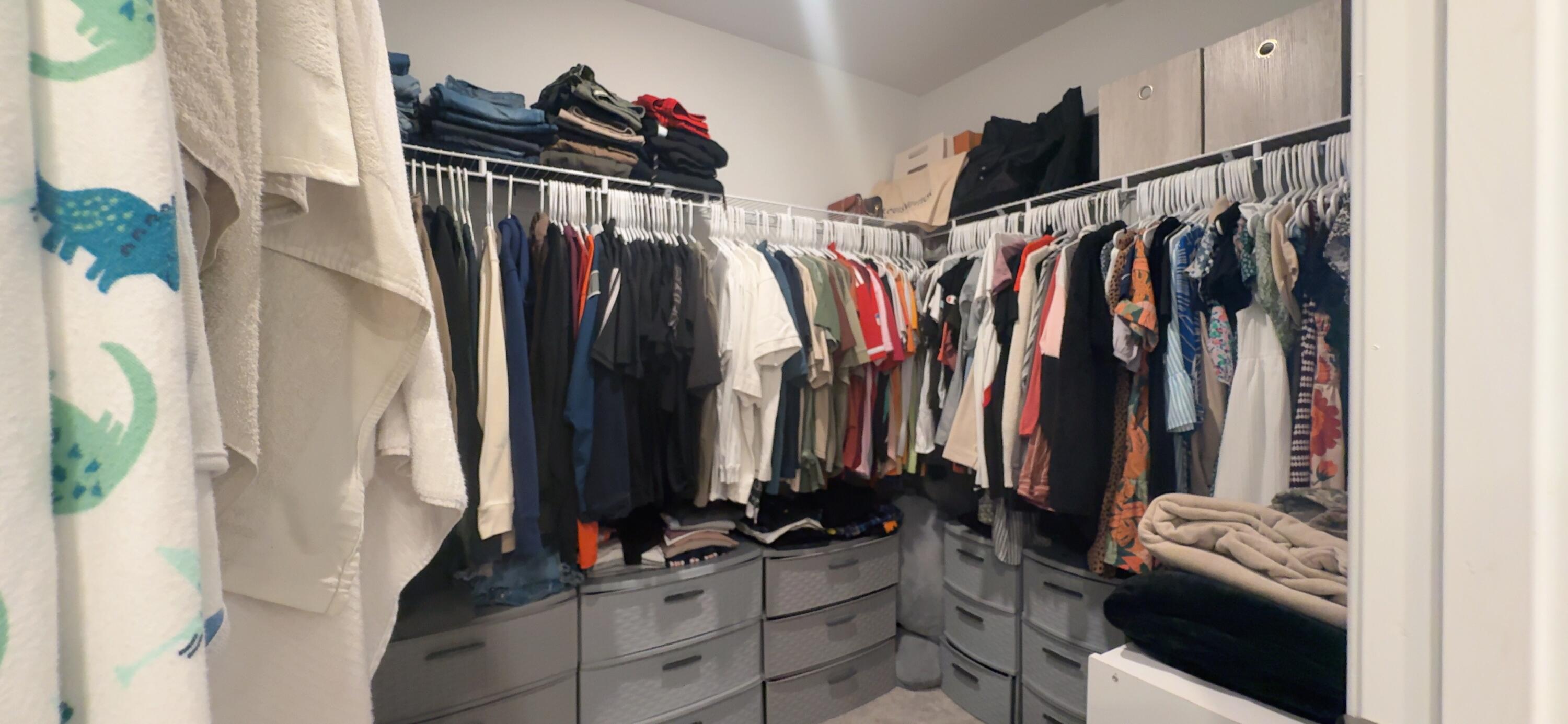 682 Papillon Street Southwest Palm Bay, FL 32908 - Photo 30 of 30 a view of walk in closet with clothes and shoes