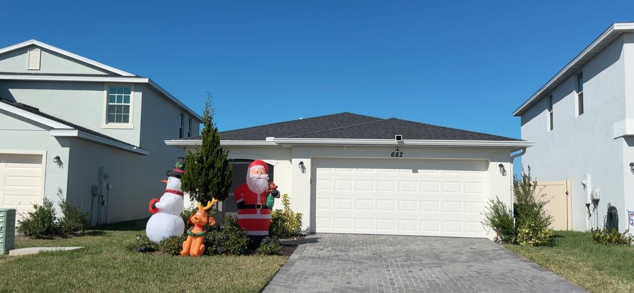 682 Papillon Street Southwest Palm Bay, FL 32908 - Photo 3 of 30 a front view of a house with garden