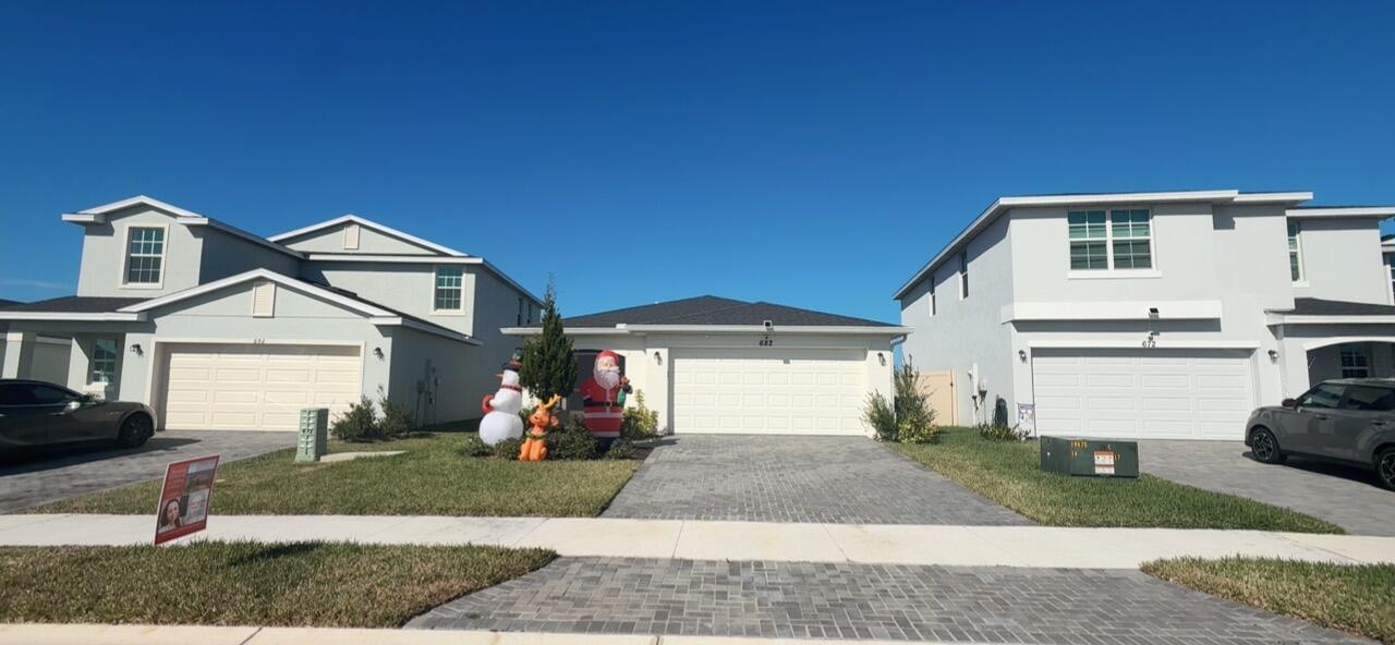 682 Papillon Street Southwest Palm Bay, FL 32908 - Photo 4 of 30 a front view of a house with a yard