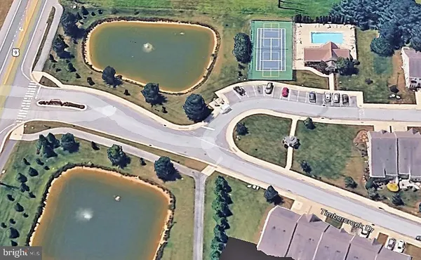 an aerial view of a house with a swimming pool patio and outdoor seating
