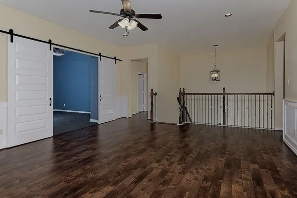 a view of empty room with wooden floor