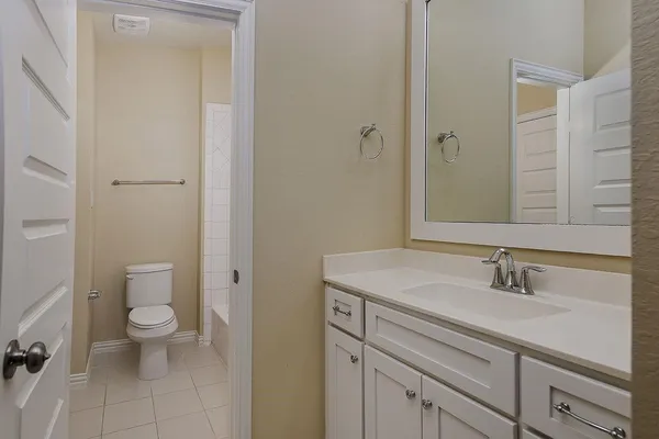 a view of bathroom with a sink toilet and a mirror