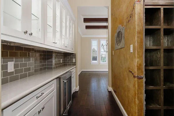 a kitchen with cabinets and wooden floor