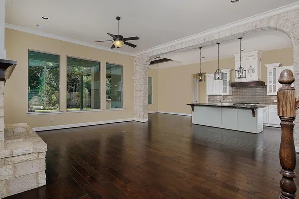 a view of a kitchen with a sink wooden floor and a window