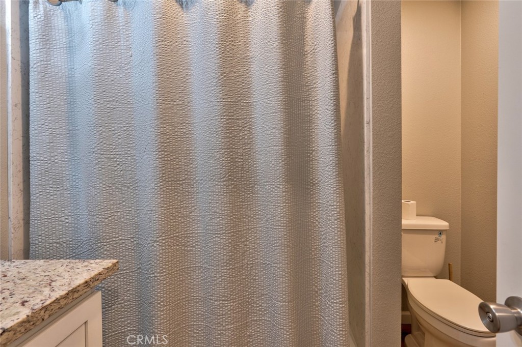 1840 Cheyenne Drive Merced, CA 95348 - Photo 37 of 90 a bathroom with a granite countertop sink and toilet