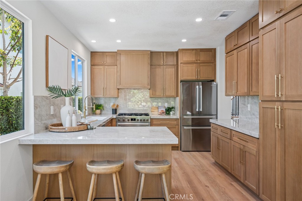 38 San Raphael Dana Point, CA 92629 - Photo 11 of 38 a kitchen with stainless steel appliances granite countertop a refrigerator a sink dishwasher a stove and white countertops with wooden floor