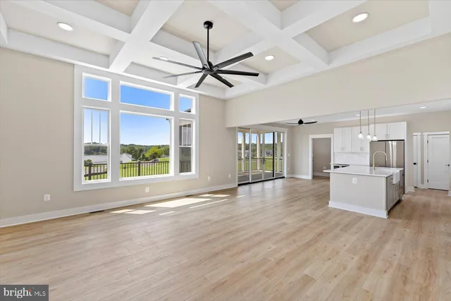 a kitchen with granite countertop white cabinets and stainless steel appliances