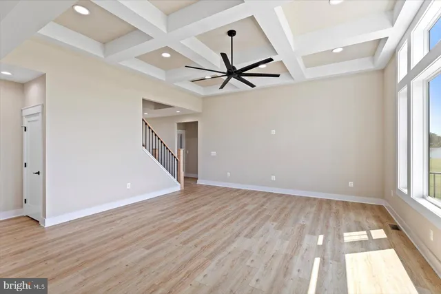 a kitchen with kitchen island a refrigerator a sink and a stove