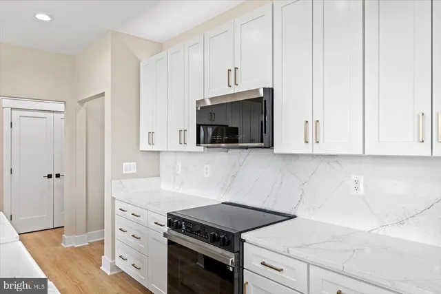 a view of kitchen with sink and refrigerator