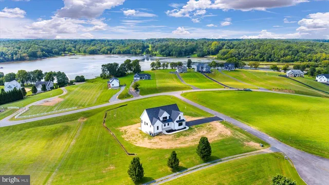a view of a swimming pool with a patio and a yard