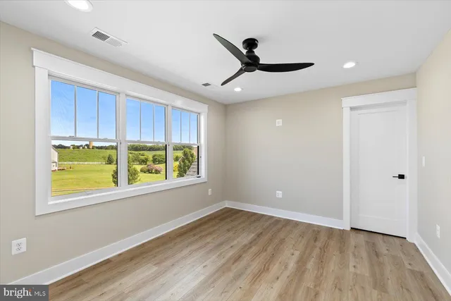 an aerial view of a house with a garden and lake view