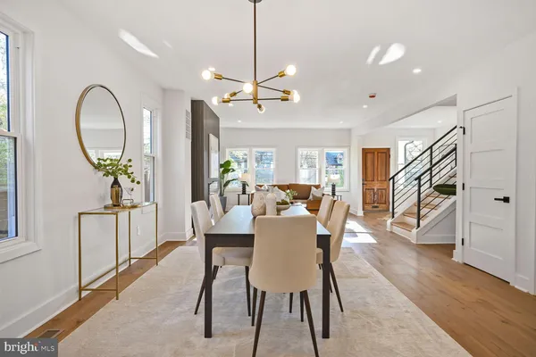 a living room with furniture kitchen and a table