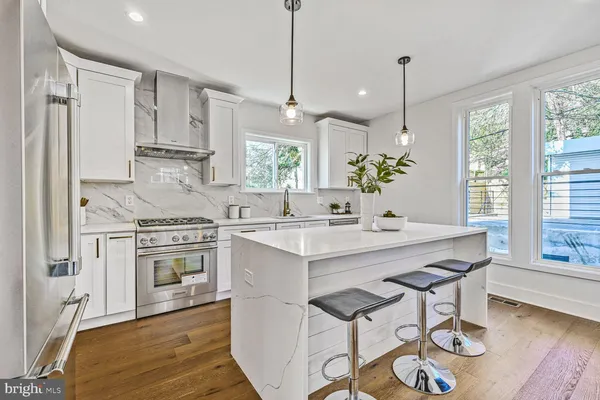 a kitchen with stainless steel appliances a sink stove and cabinets