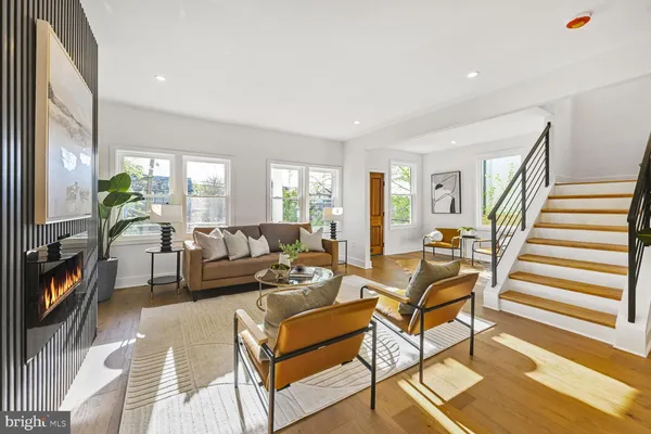 a living room with patio furniture and a flat screen tv