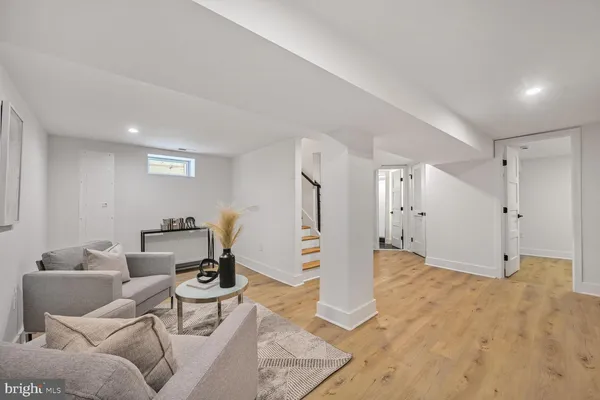 a view of a livingroom with wooden floor and furniture