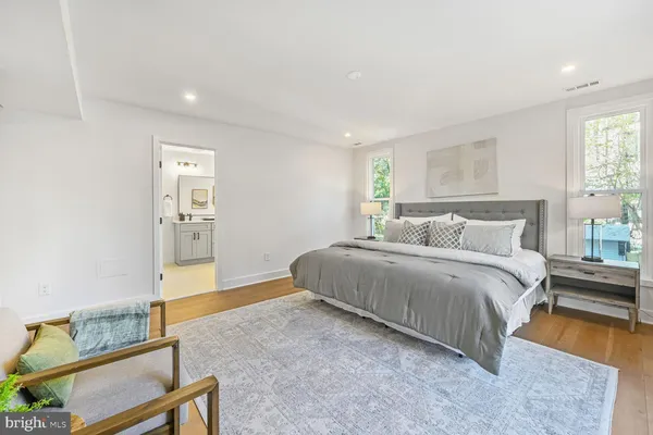 a spacious bedroom with a bed and a large window