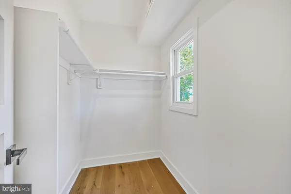 a bathroom with a bathtub shower sink vanity mirror and toilet