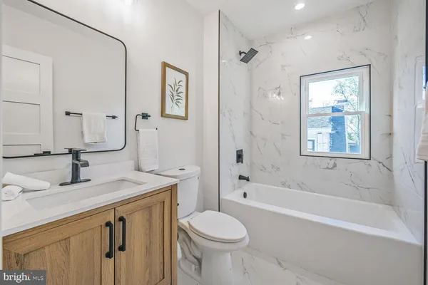 a spacious bathroom with a double vanity sink mirror double shower and a bathtub