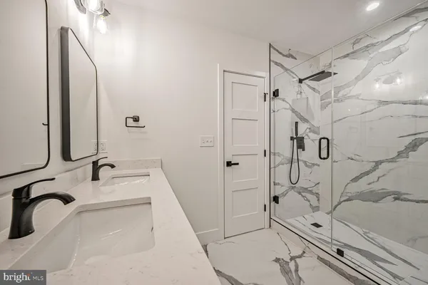 a bathroom with a toilet sink a mirror and a window