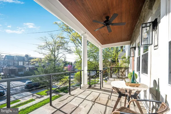 a view of a porch with furniture and a backyard