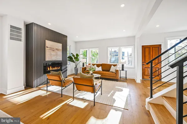 a living room with furniture a rug and a window