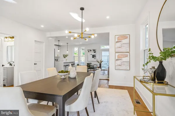 a view of a dining room with furniture and a chandelier