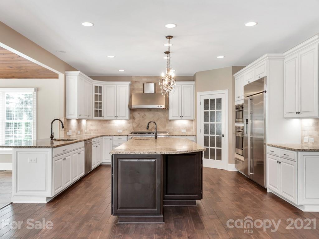 225 Cattle Ridge Road Marvin, NC 28173 - Photo 11 of 42 a kitchen with stainless steel appliances granite countertop a sink stove and refrigerator