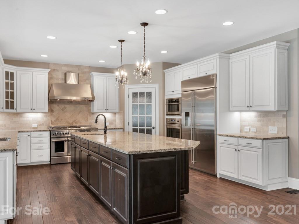 225 Cattle Ridge Road Marvin, NC 28173 - Photo 12 of 42 a kitchen with stainless steel appliances granite countertop a sink stove and refrigerator