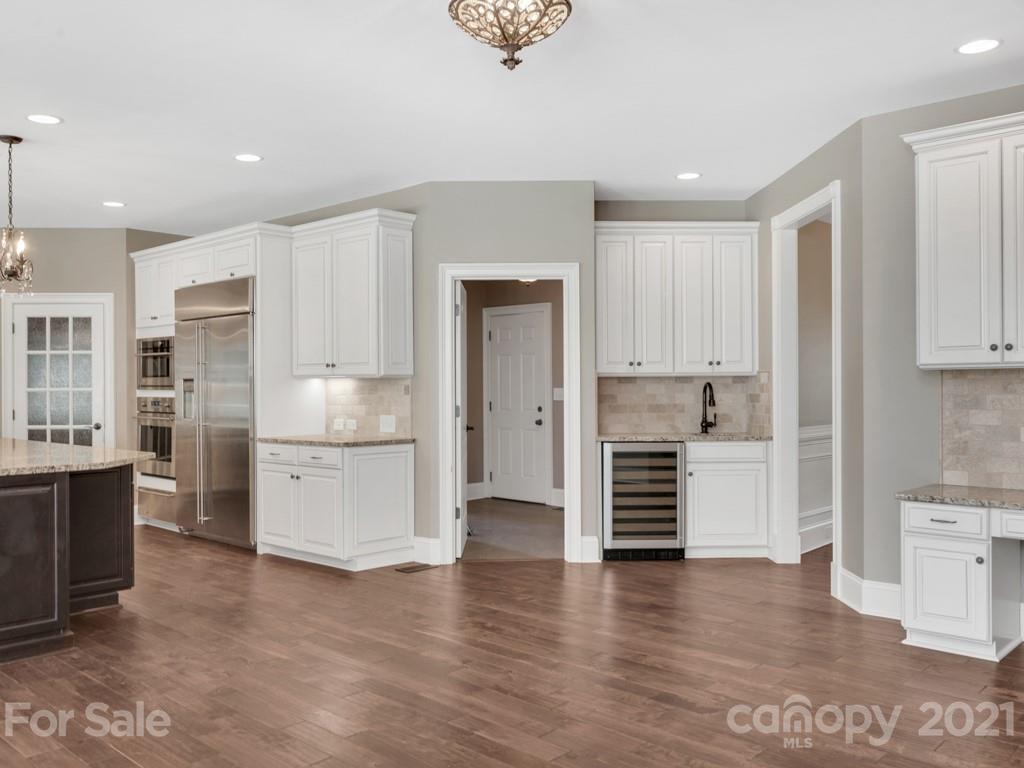 225 Cattle Ridge Road Marvin, NC 28173 - Photo 13 of 42 a kitchen with a refrigerator and white cabinets
